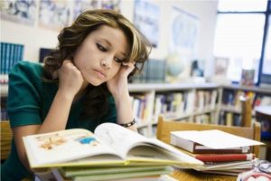 Student taking her time to read 15 habits of highly successful students