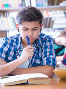 student reading and thinking Student Studying and coming up with some important questions
