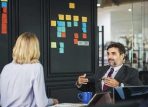 customer-centric man talking to a female customer